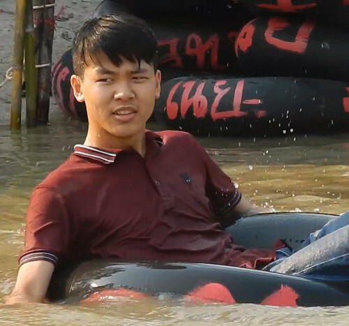 Swimming in jeans and polo shirt