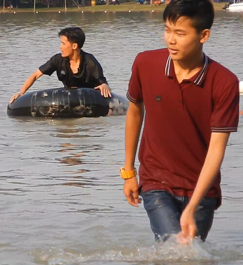 Swimming in jeans and polo shirt